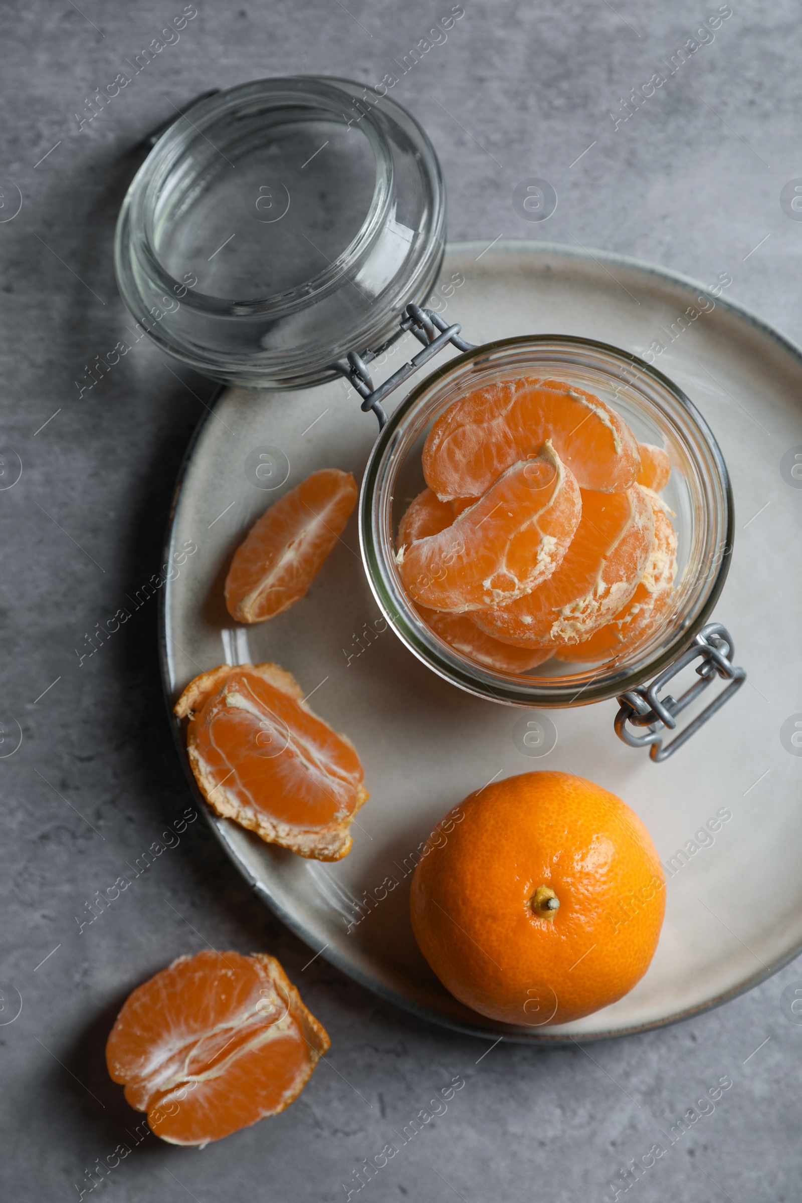 Photo of Fresh ripe tangerines on grey table, flat lay