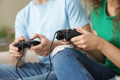 Photo of Young couple playing video games at home, closeup