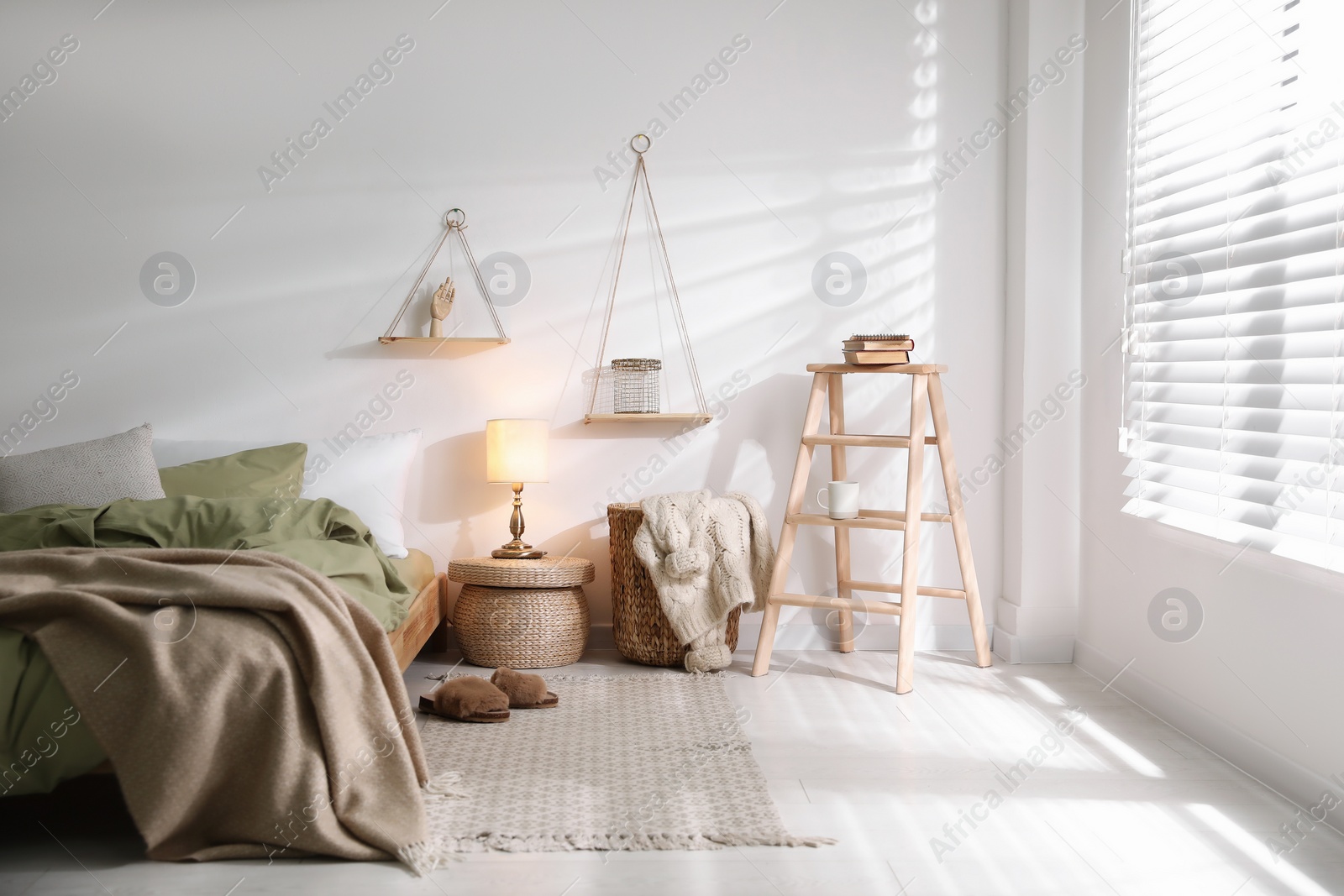 Photo of Comfortable bed with olive green linen in modern room interior