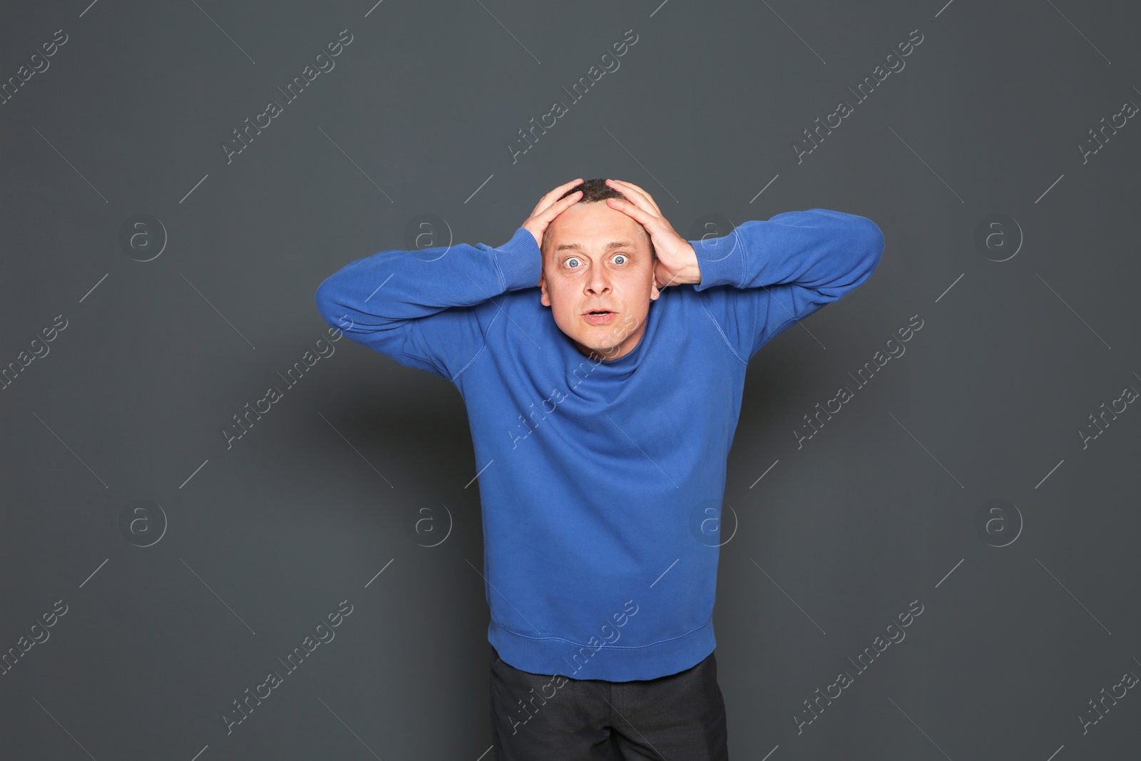 Photo of Portrait of emotional mature man on dark background