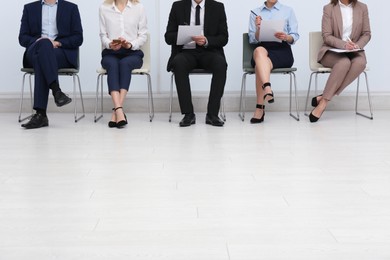 People waiting for job interview in office hall, closeup