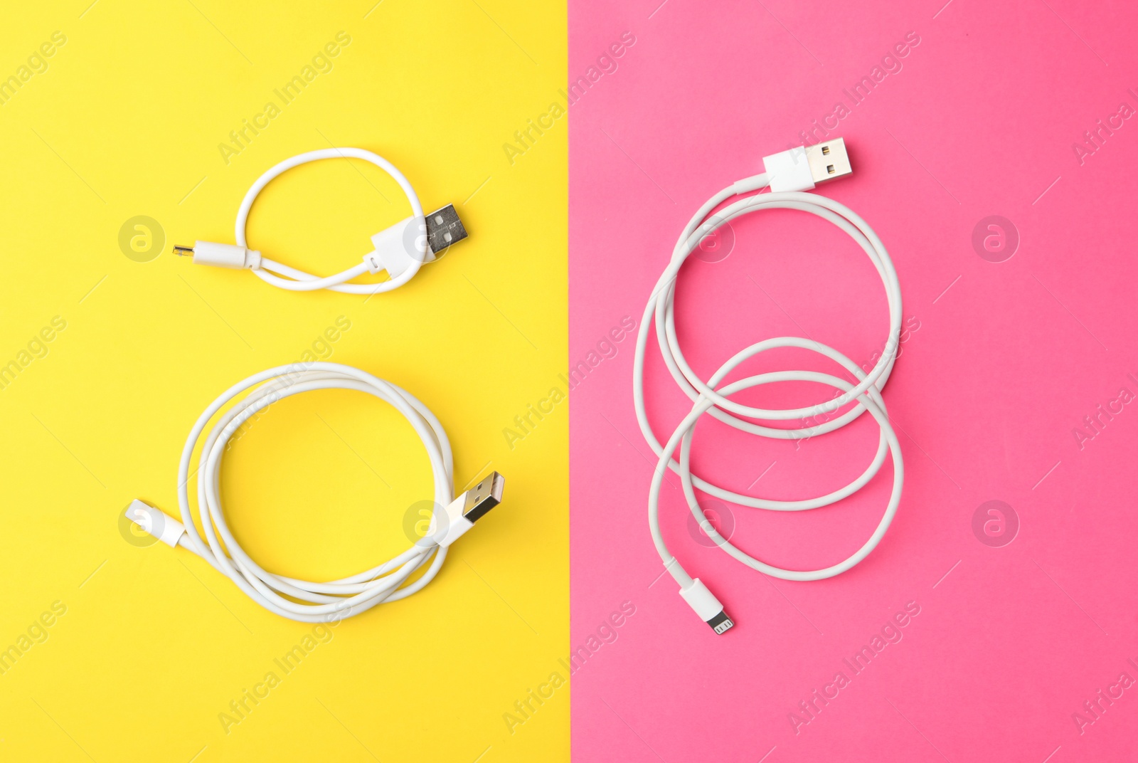 Photo of USB charge cables on color background, flat lay