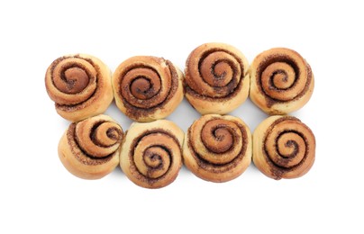 Photo of Many tasty cinnamon rolls isolated on white, top view