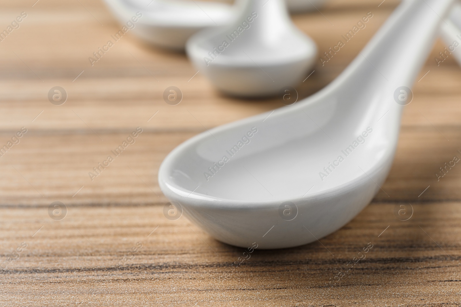 Photo of Miso soup spoon on wooden table, closeup