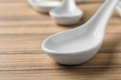 Photo of Miso soup spoon on wooden table, closeup