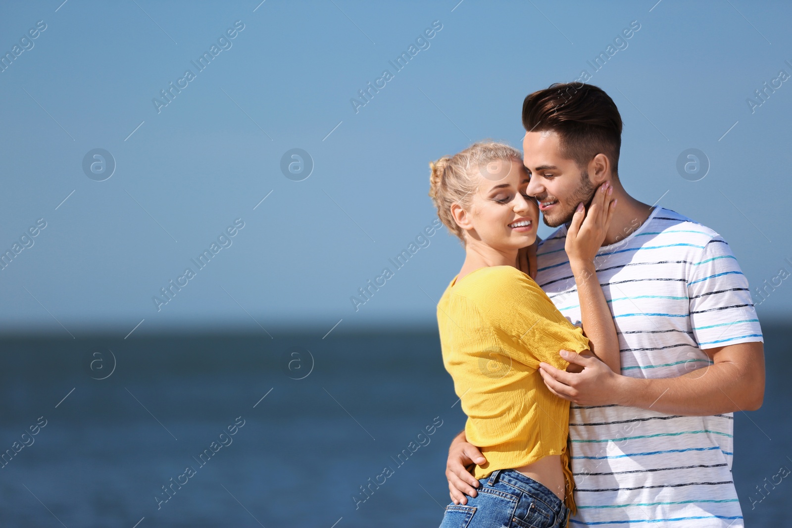 Photo of Happy young couple at beach on sunny day