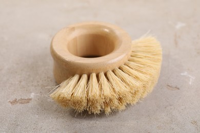 Photo of Cleaning brush on light grey table, closeup