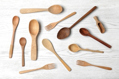 Photo of Flat lay composition with wooden cutlery on white wooden table