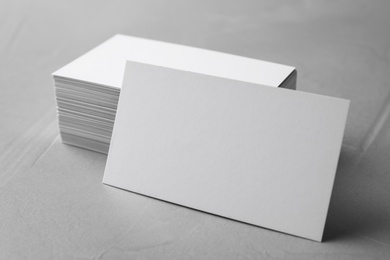 Photo of Stack of empty sheets on grey stone table. Mock up for design