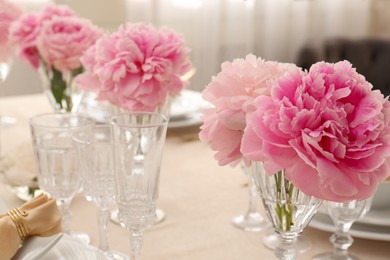 Photo of Stylish table setting with beautiful peonies indoors. Space for text