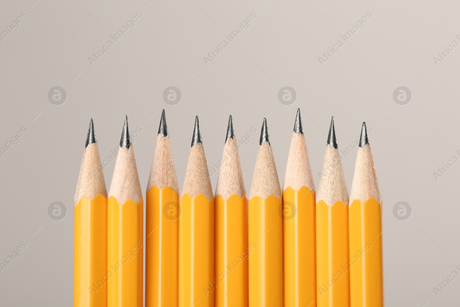 Photo of Many sharp graphite pencils on grey background, space for text. Macro view