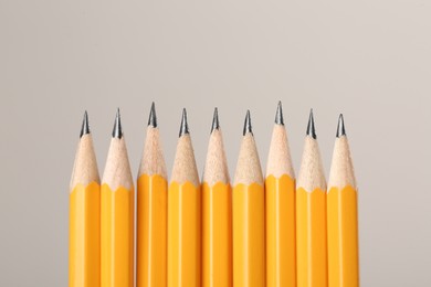 Photo of Many sharp graphite pencils on grey background, space for text. Macro view