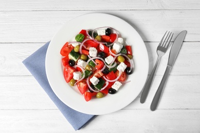 Photo of Plate with delicious salad on table, top view