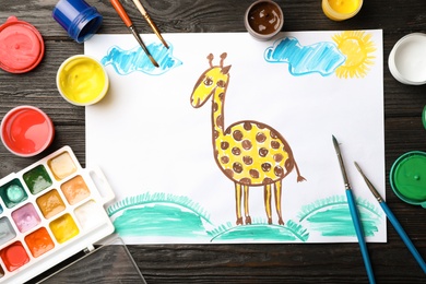 Flat lay composition with child's painting of giraffe on table