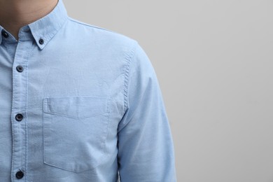 Photo of Man wearing clean shirt on white background, closeup. Space for text