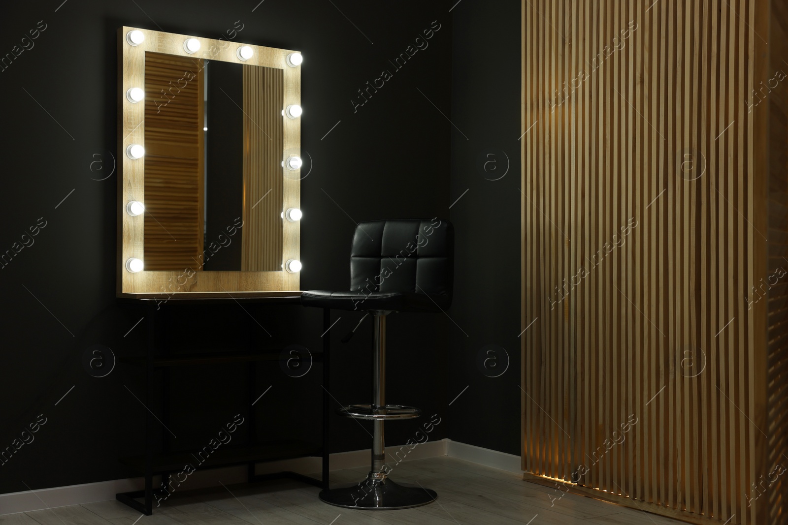 Photo of Beautiful mirror with light bulbs and chair in makeup room