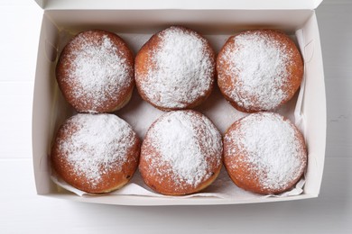 Photo of Delicious sweet buns in box on table, top view