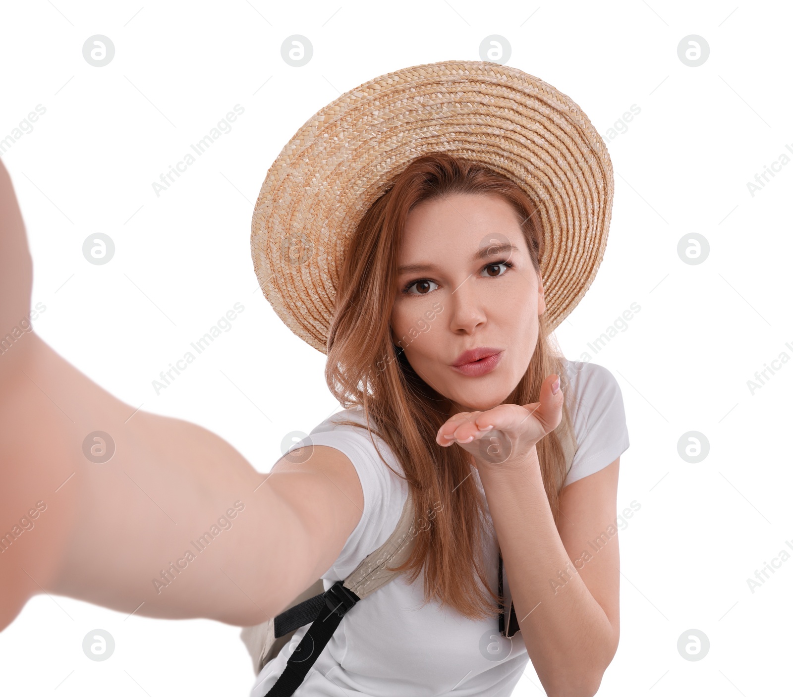 Photo of Beautiful woman in straw hat taking selfie on white background