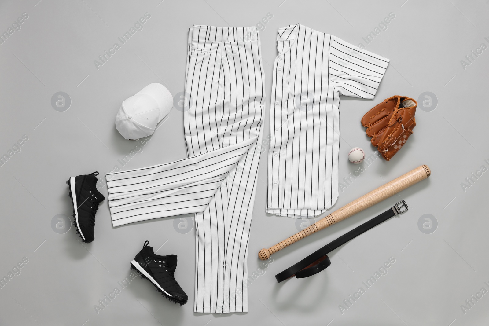 Photo of Flat lay composition with baseball uniform on white background