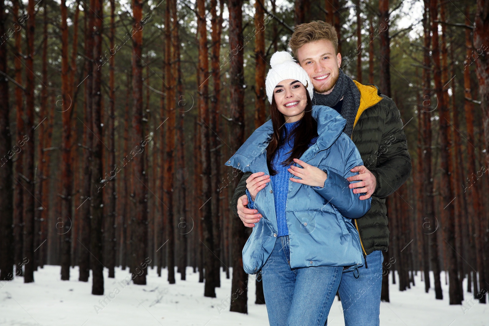 Photo of Beautiful young couple in snowy winter forest