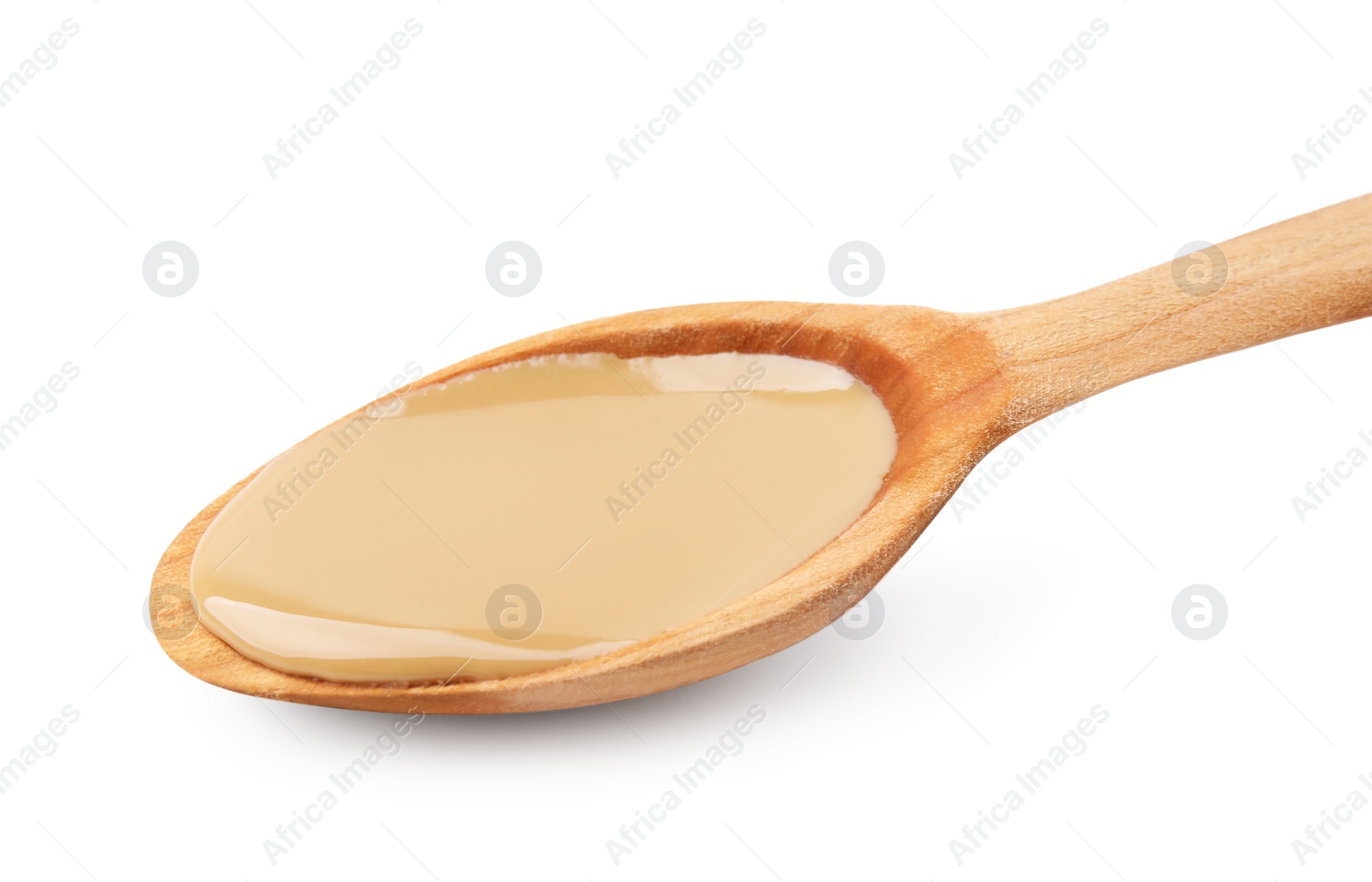 Photo of Wooden spoon with tasty peanut butter isolated on white