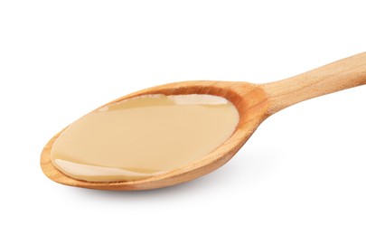 Wooden spoon with tasty peanut butter isolated on white