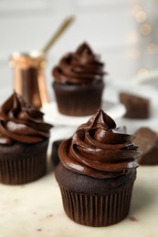 Delicious chocolate cupcake with cream on table. Space for text