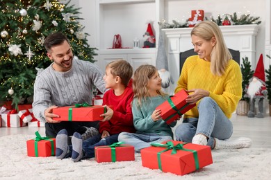 Photo of Happy family with Christmas gifts at home