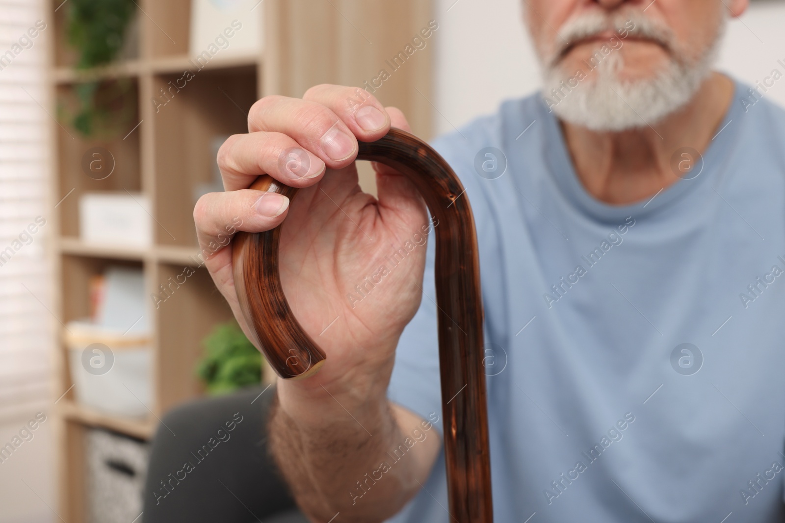 Photo of Senior man with walking cane at home, closeup