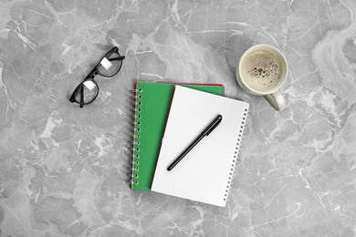 Photo of Flat lay composition with office stationery and cup of coffee on marble table