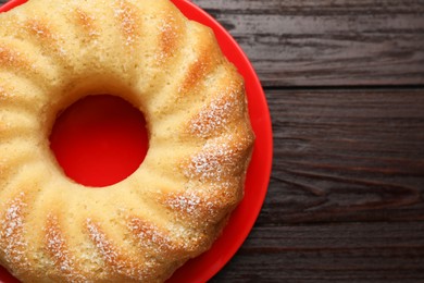 Photo of Delicious freshly baked sponge cake on wooden table, top view. Space for text