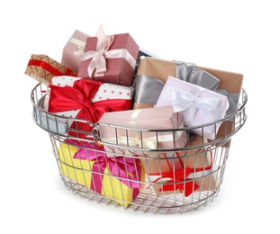 Photo of Shopping basket full of gift boxes on white background