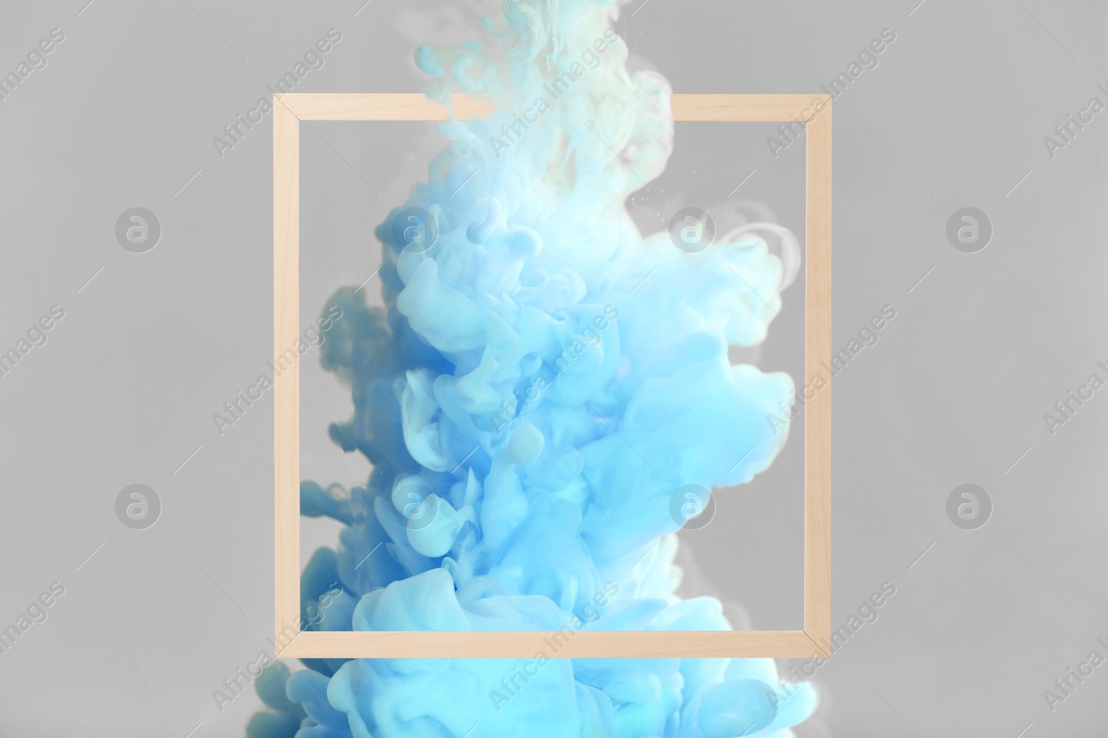 Image of Splash of light blue ink and frame on grey background