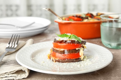 Photo of Baked eggplant with tomatoes, cheese and basil on plate