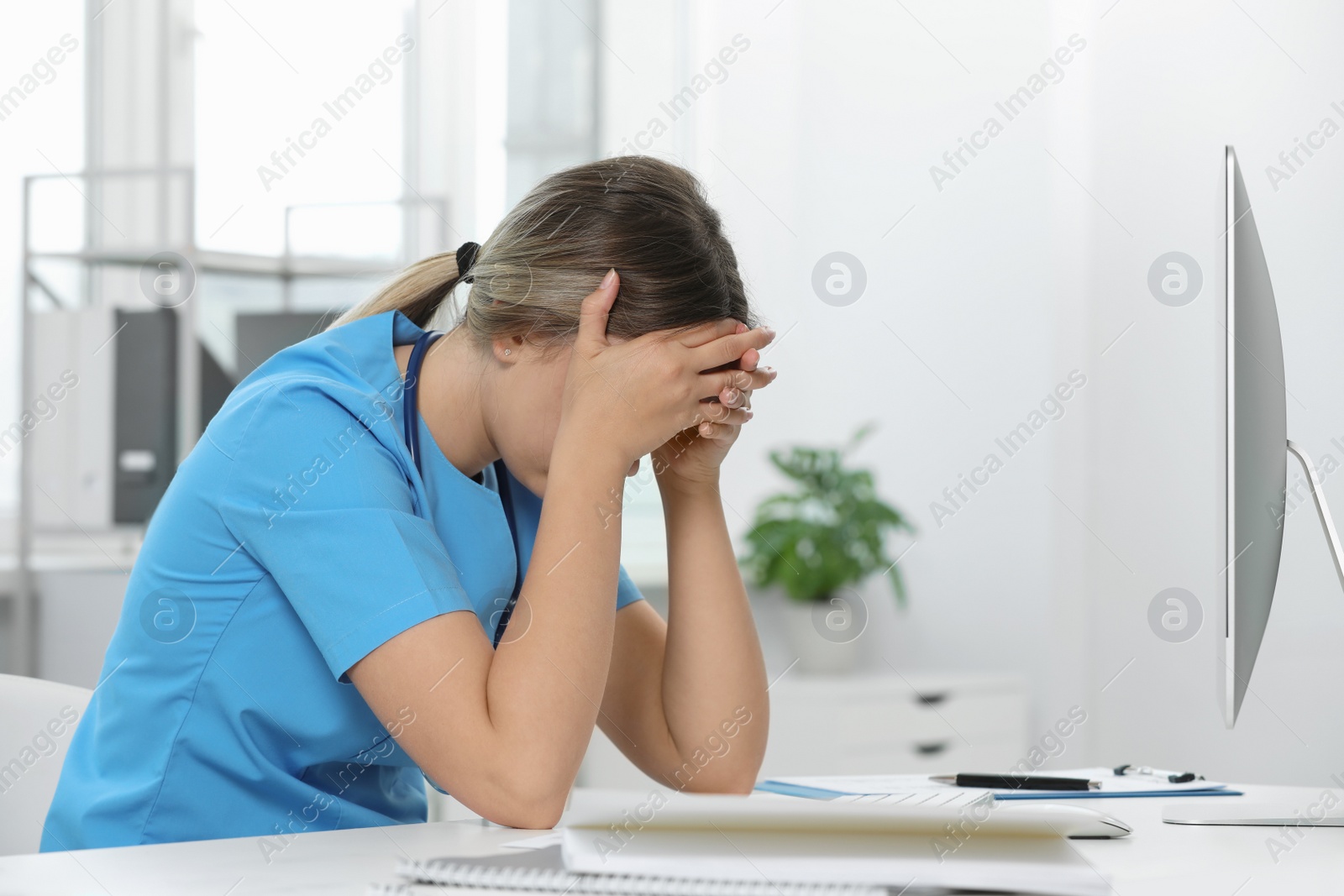 Photo of Exhausted doctor at workplace in hospital, space for text