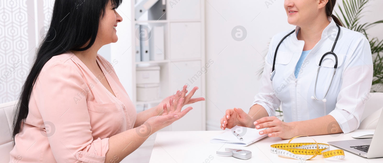 Image of Overweight mature woman consulting with nutritionist in clinic. Banner design