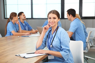 Medical student with groupmates in university library