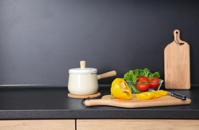 Composition with kitchenware and products on countertop. Space for text