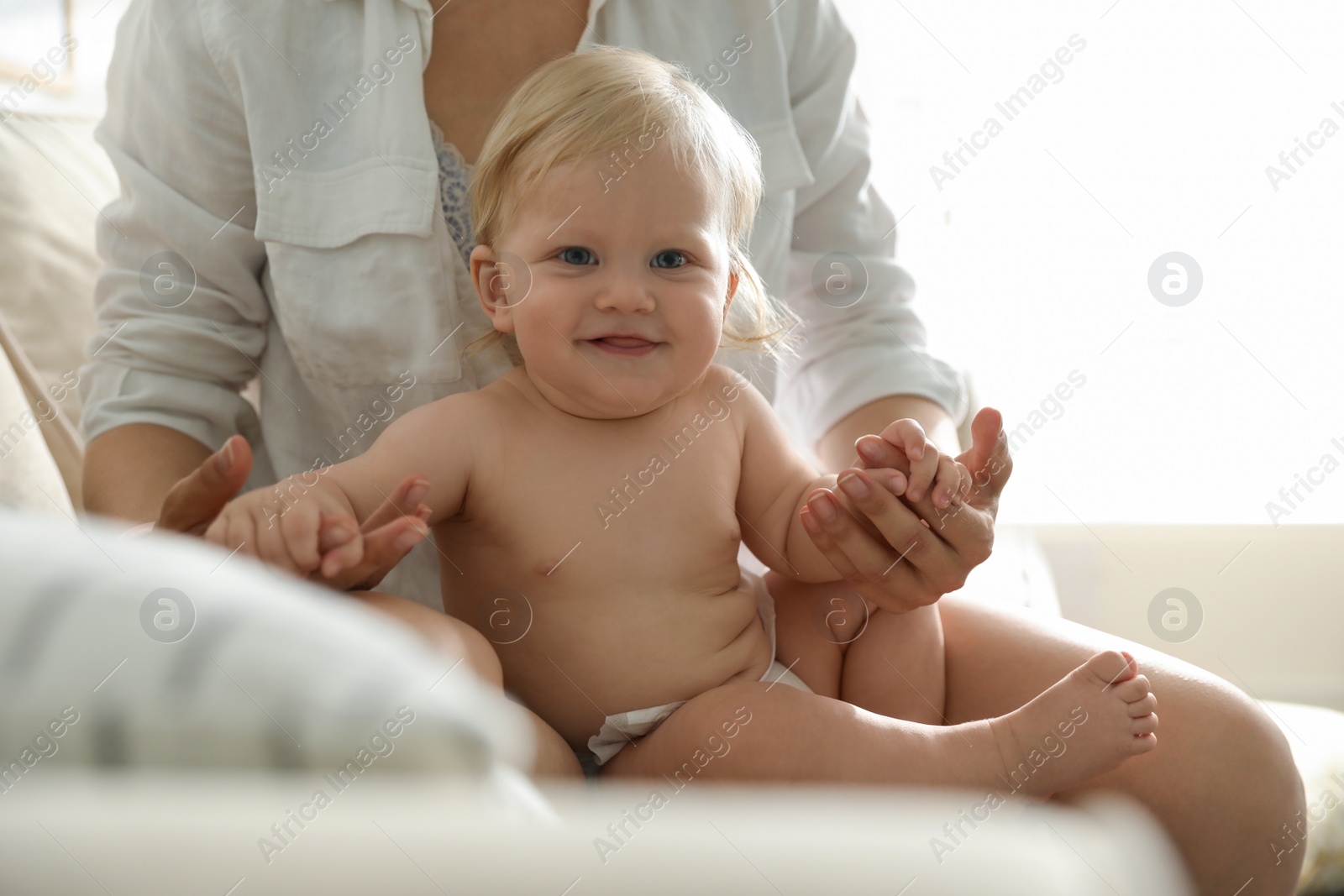 Photo of Mother and her cute little baby at home. Healthy growth