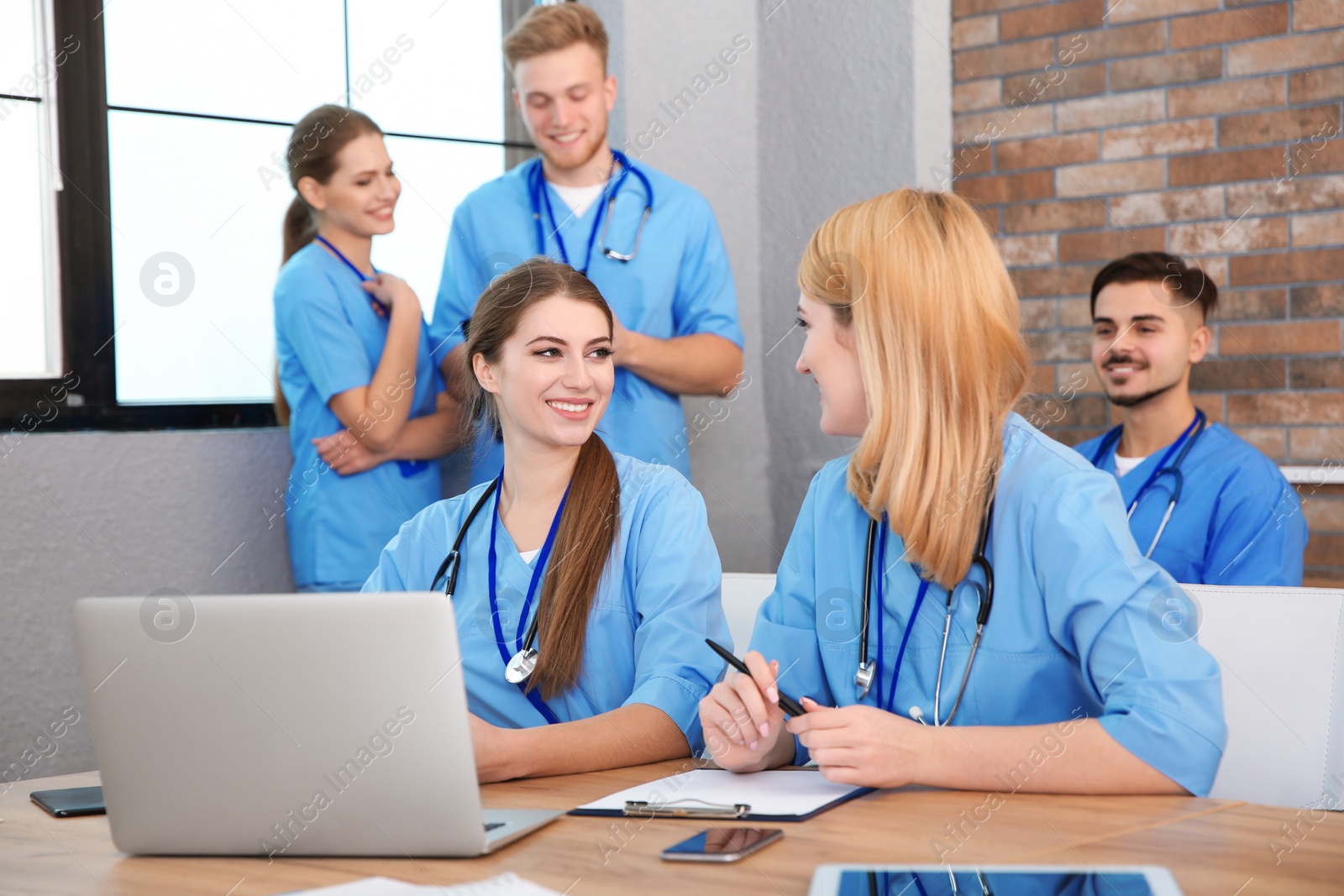 Photo of Medical students in uniforms studying at university