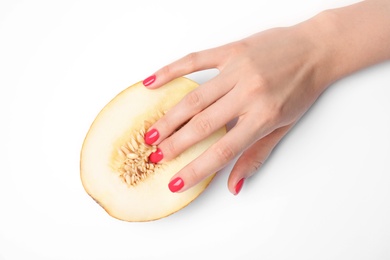 Photo of Young woman touching half of melon on white background, top view. Sex concept