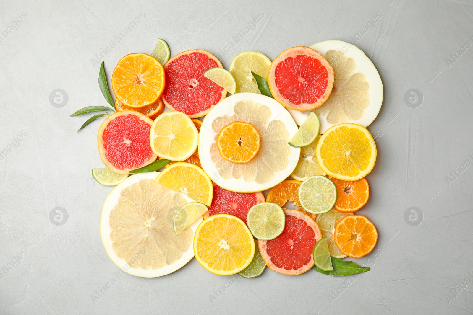 Photo of Different citrus fruits on grey background, top view