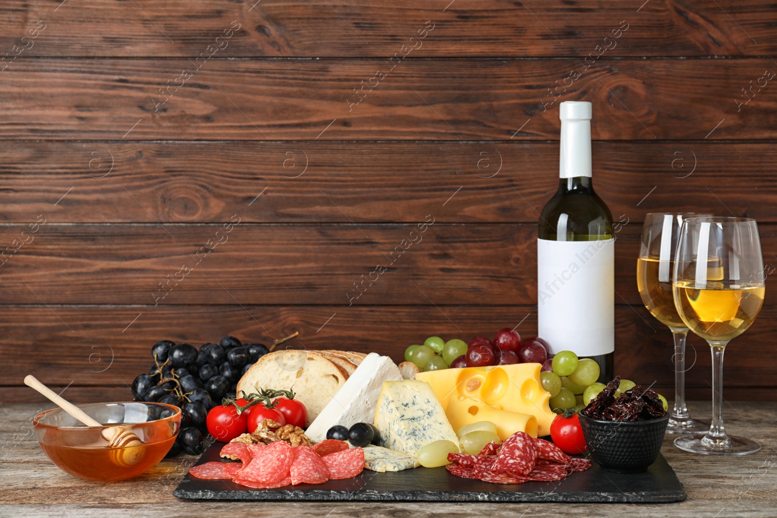 Photo of Composition with wine and snacks on table. Space for text