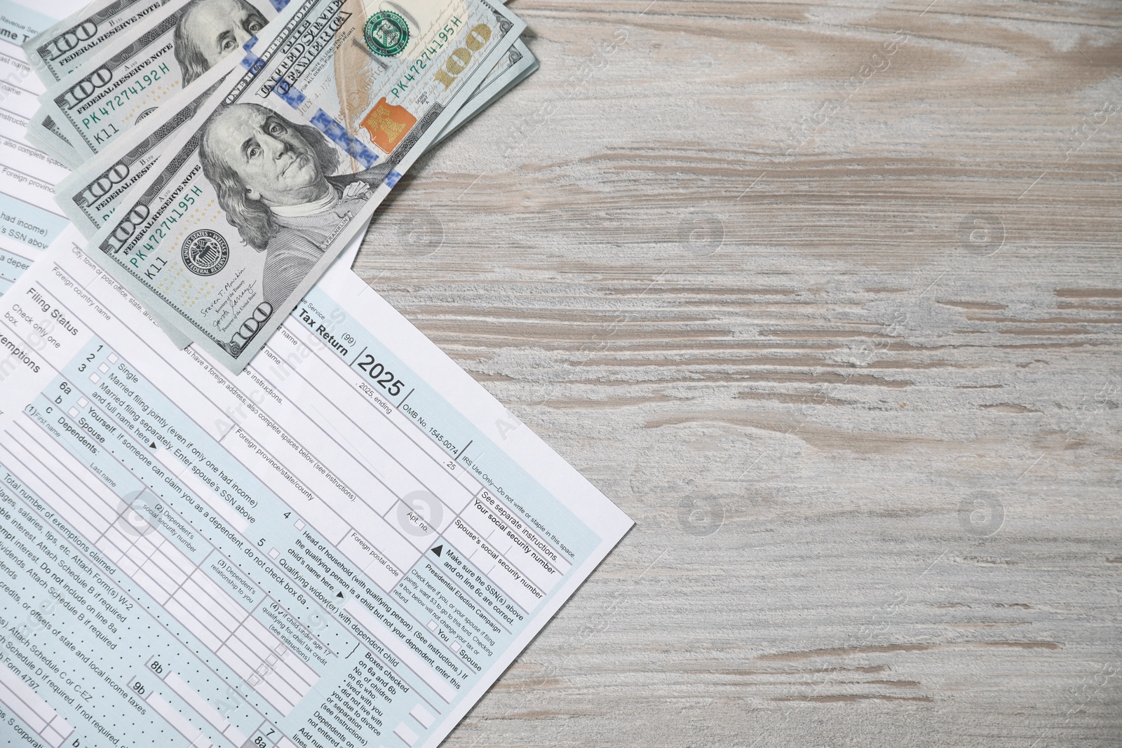 Photo of Payroll. Tax return forms and dollar banknotes on wooden table, flat lay. Space for text