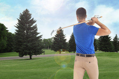 Image of Young man playing golf on course with green grass, back view. Space for design