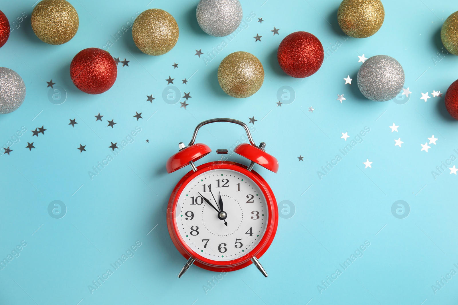 Photo of Flat lay composition with alarm clock and beautiful decorations on color background. Christmas countdown