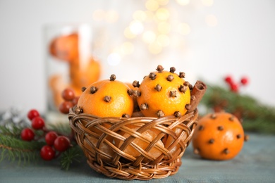 Pomander balls made of fresh tangerines and cloves on wooden table, closeup