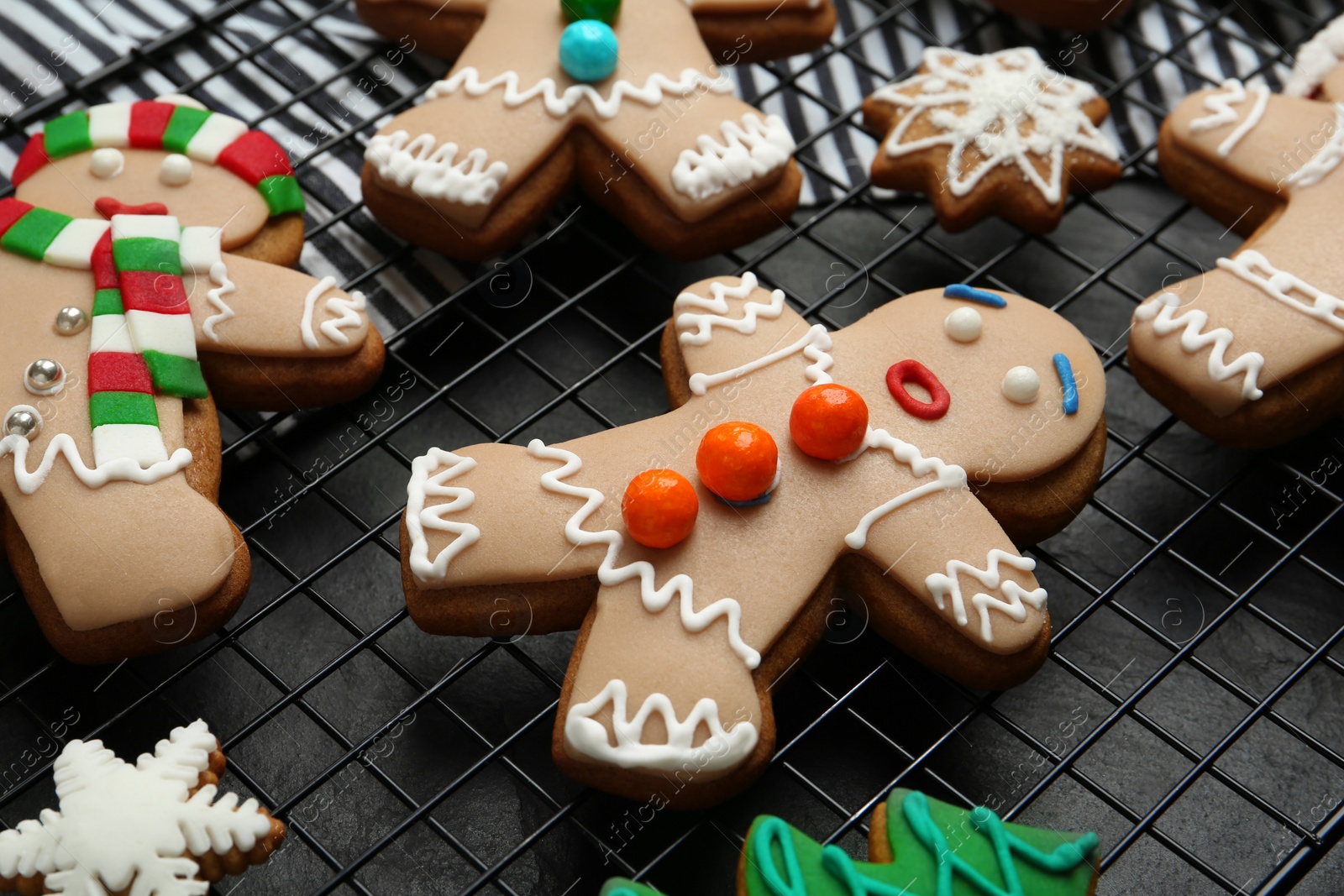 Photo of Delicious Christmas cookies on black table, closeup