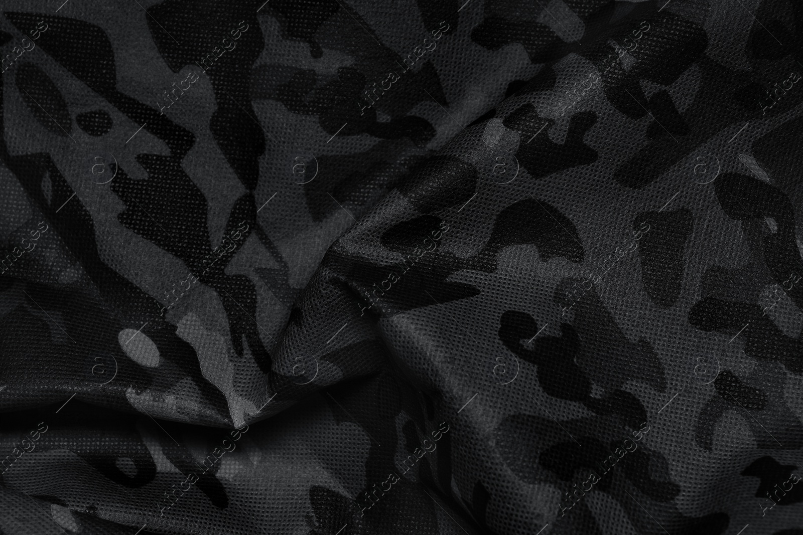 Image of Texture of crumpled camouflage fabric as background, top view. Black and white effect