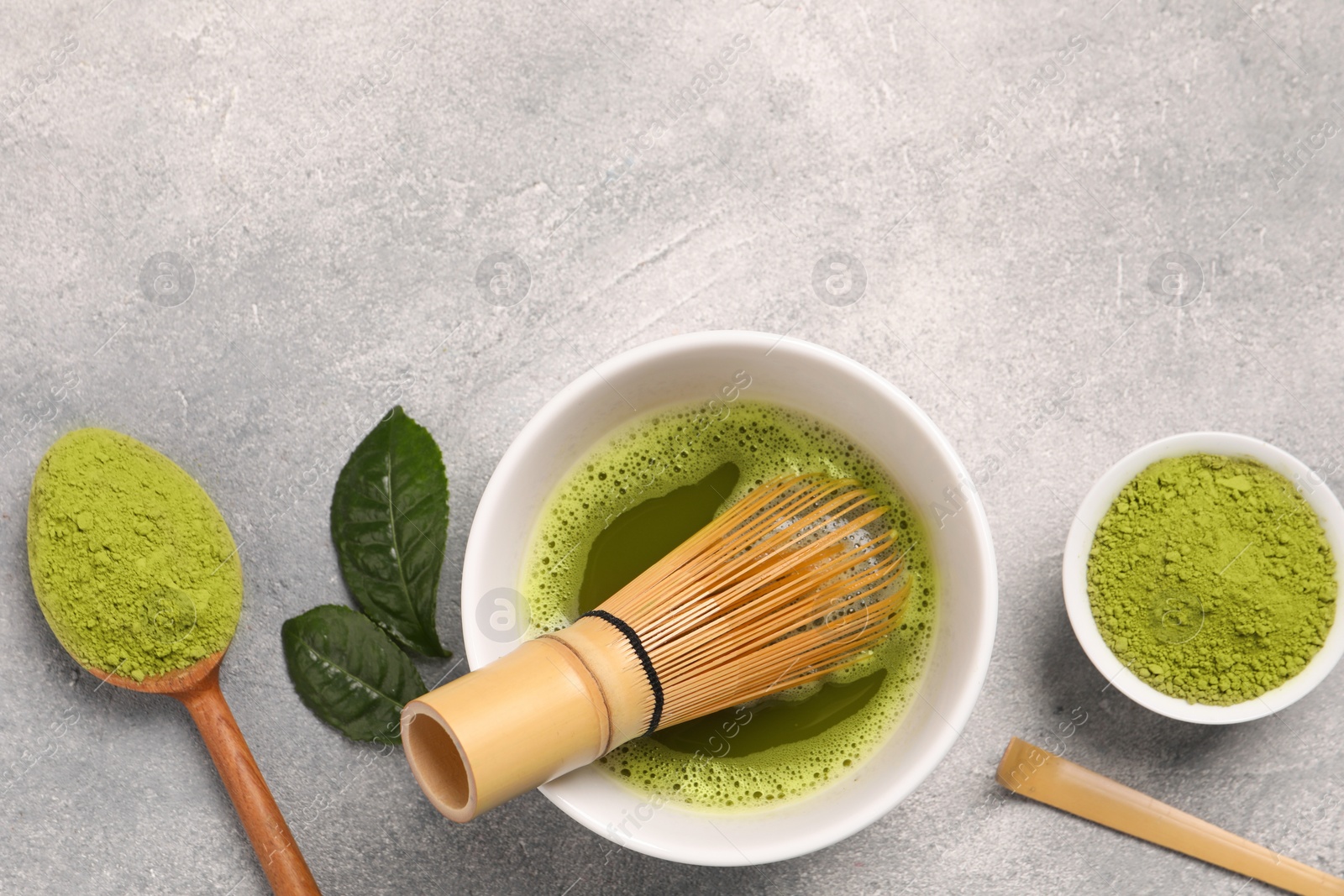 Photo of Flat lay composition with matcha tea on light gray textured table